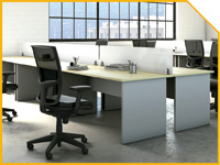 PORTADATONO3200X150 | OfficeDeco Open-plan office with grey desks, ergonomic chairs, computer monitors, and large windows in the background.